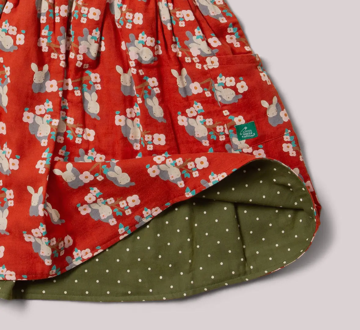 Floral-patterned fabric with a brand label on a neutral background
