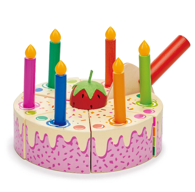 Toy birthday cake with colorful candles on a white background