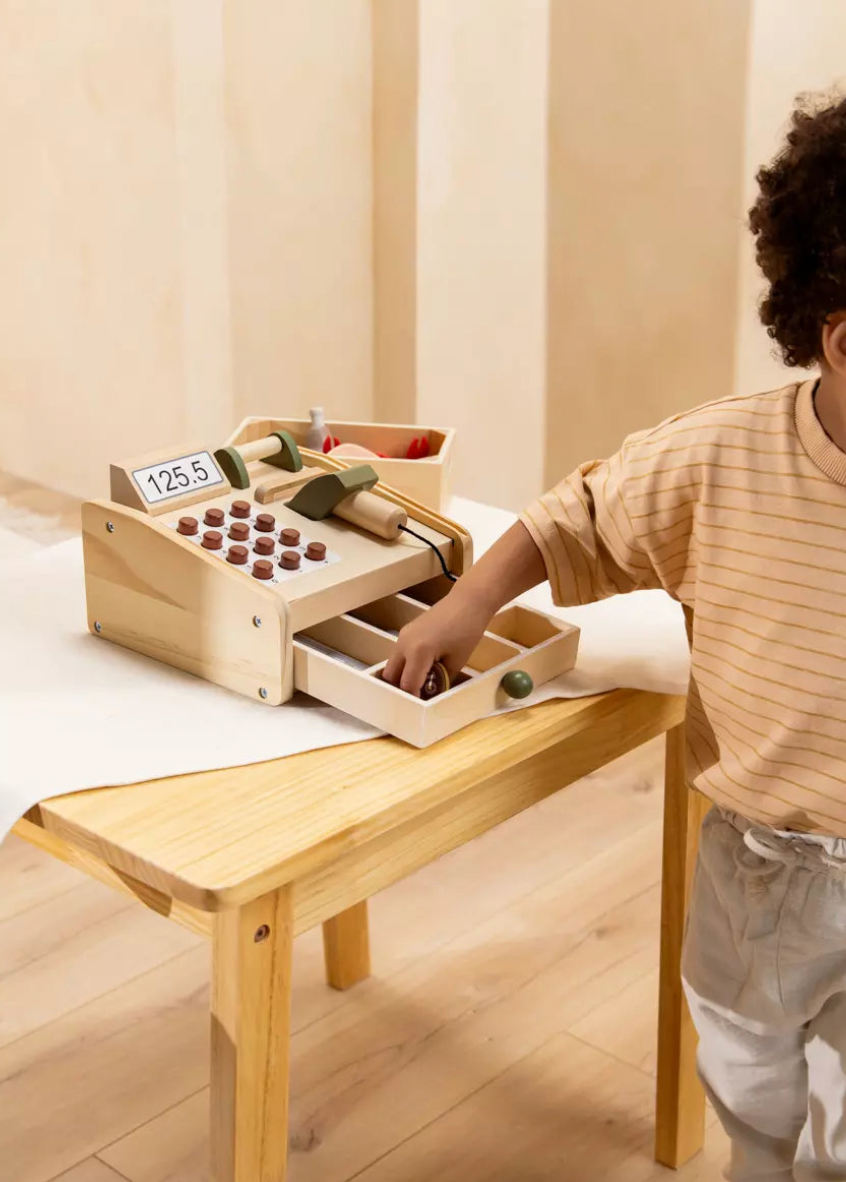 Child playing with a wooden educational toy at a table.