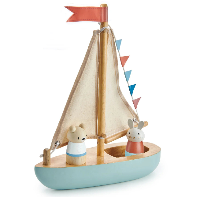Wooden toy sailboat with two animal figures and a colorful flag on a white background