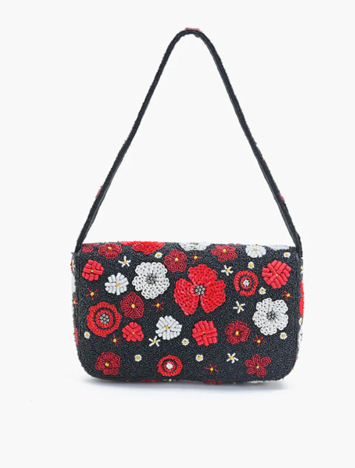 Floral patterned handbag with a strap on a white background