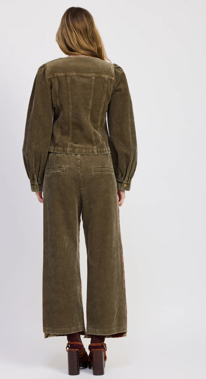 Brown corduroy jumpsuit worn by a person on a white background