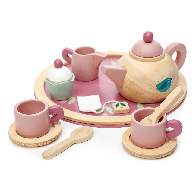 Children's toy tea set with pink teapot, cups, and utensils on a white background