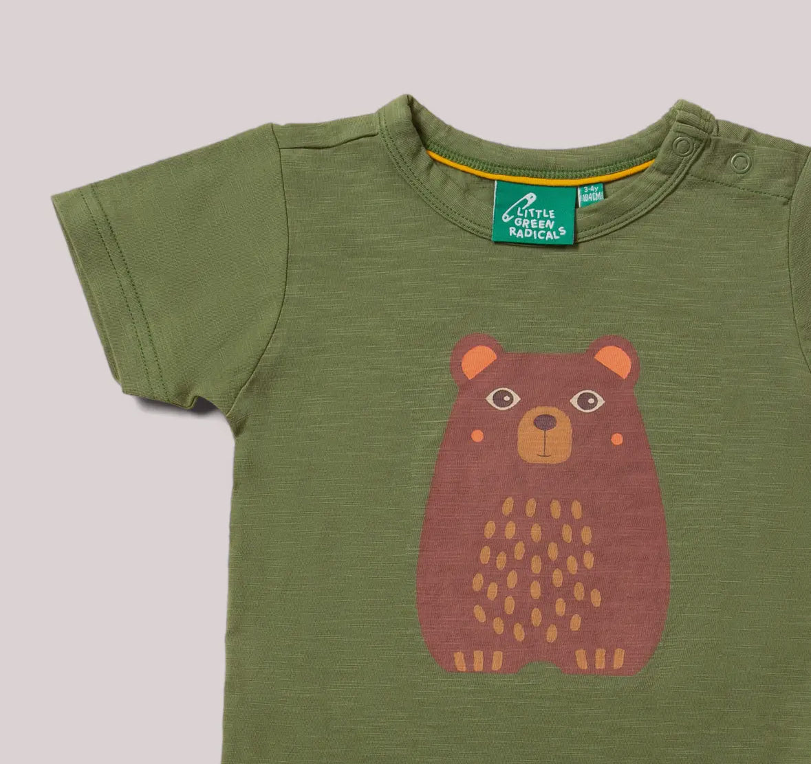 Green t-shirt with a bear design on a gray background