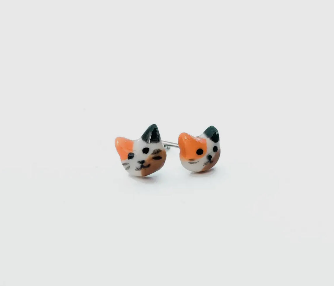 Cat-shaped earrings on a white background
