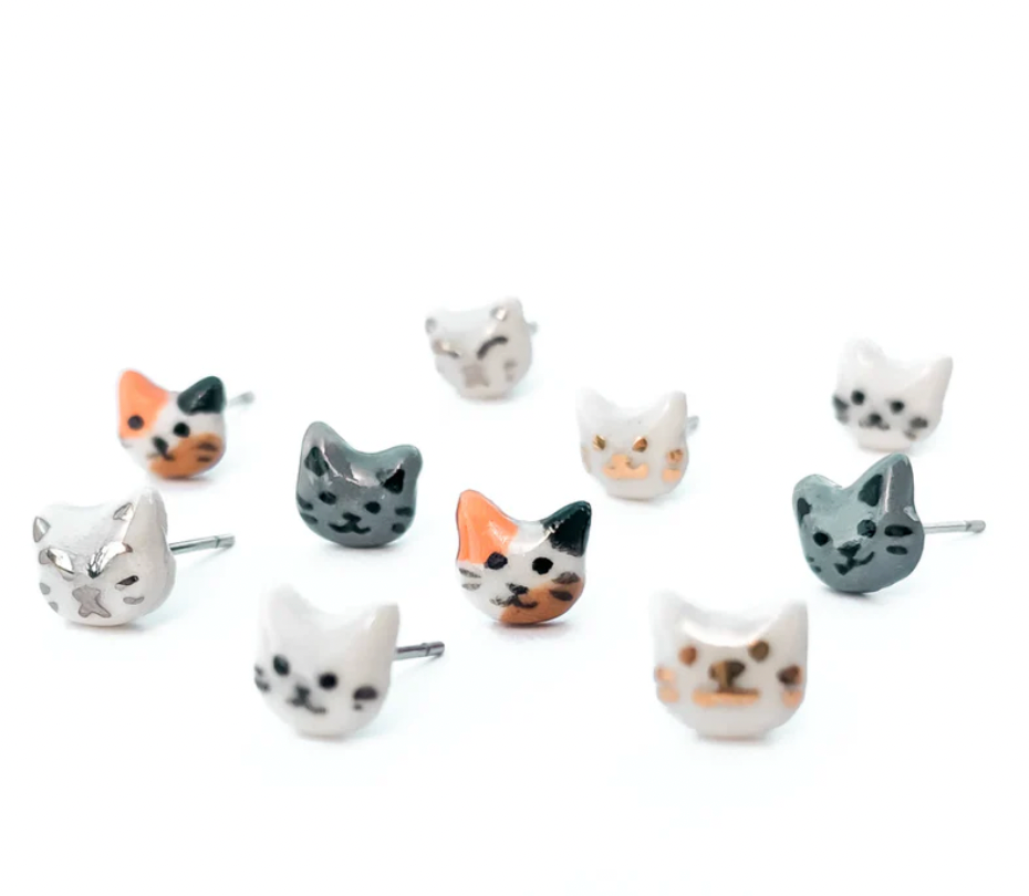 Cat-shaped earrings on a white background