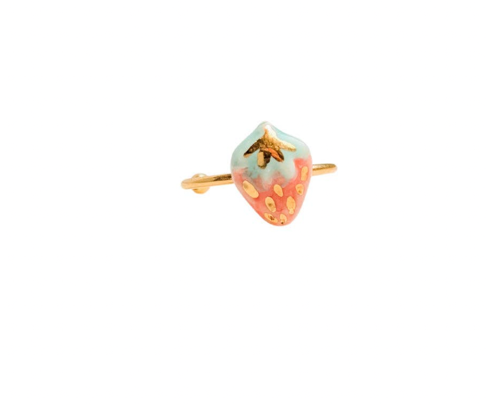 Strawberry-shaped ring with gold accents on a white background
