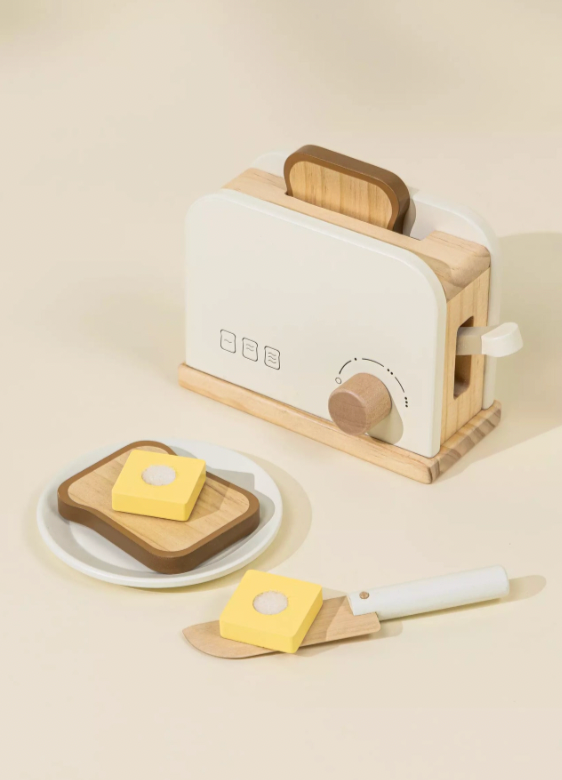 Wooden toaster with bread and butter on a beige background