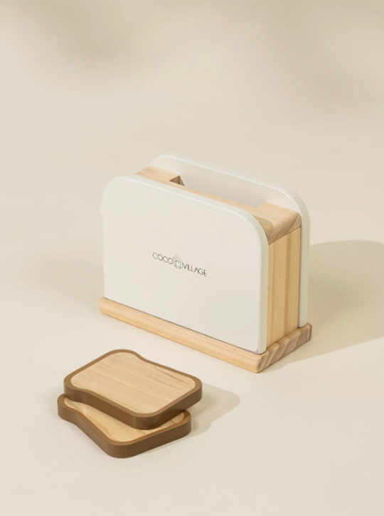 White bread toaster with wooden slices on a beige background