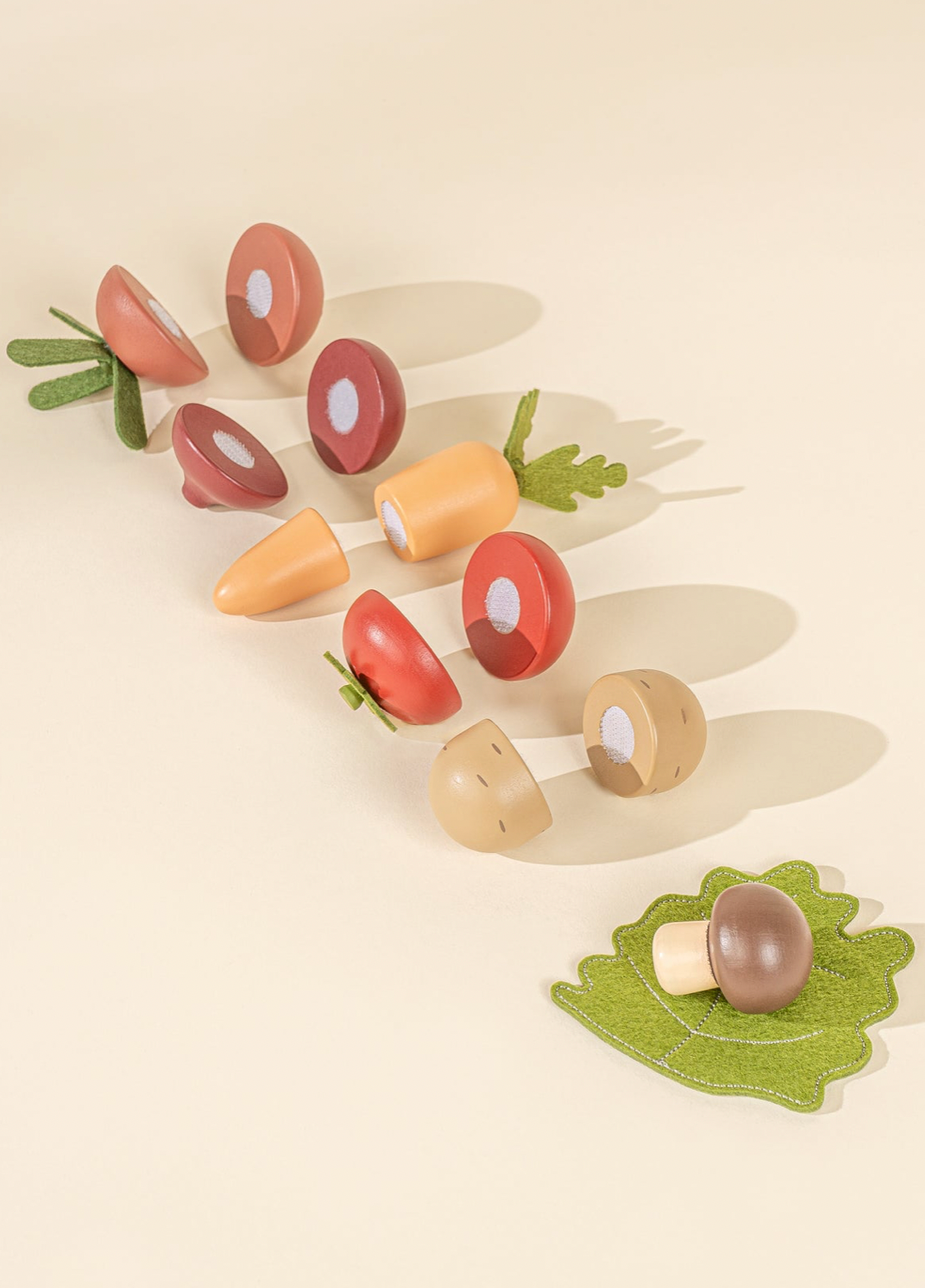 Set of wooden toy vegetables on a beige background
