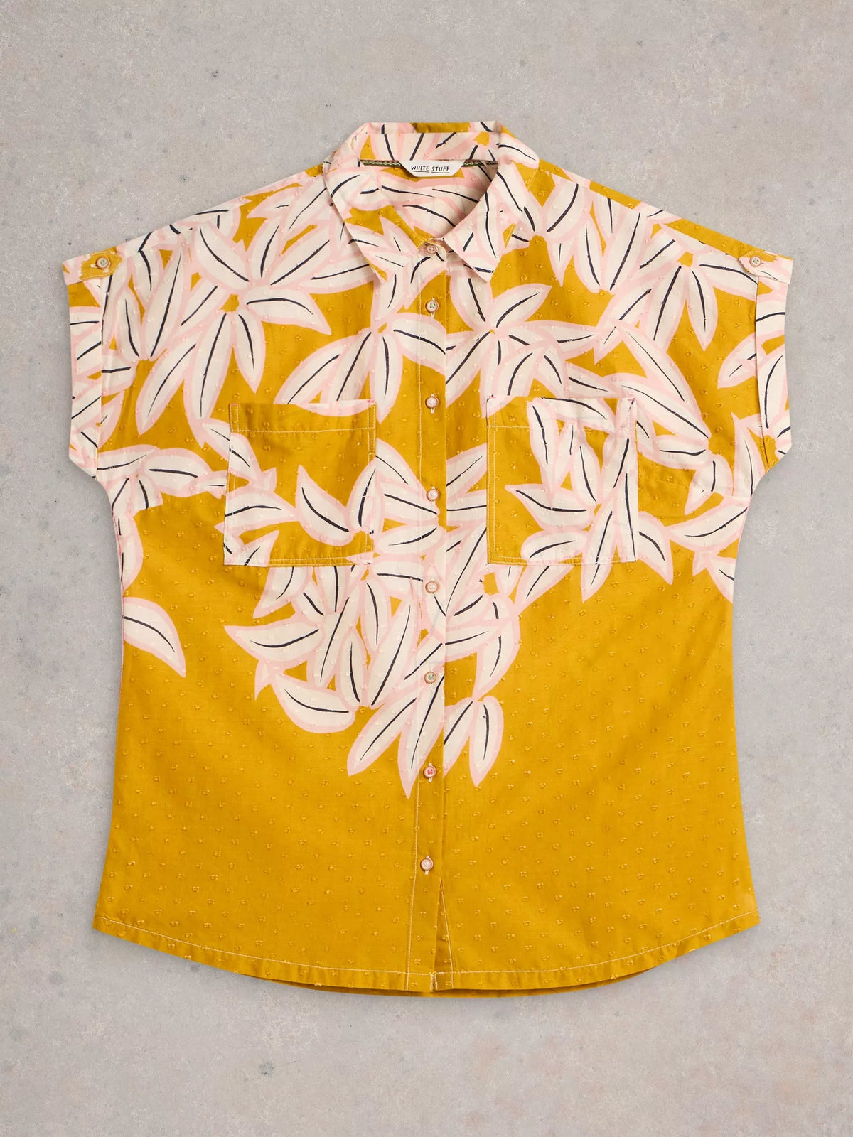 Yellow shirt with white floral pattern on a gray background