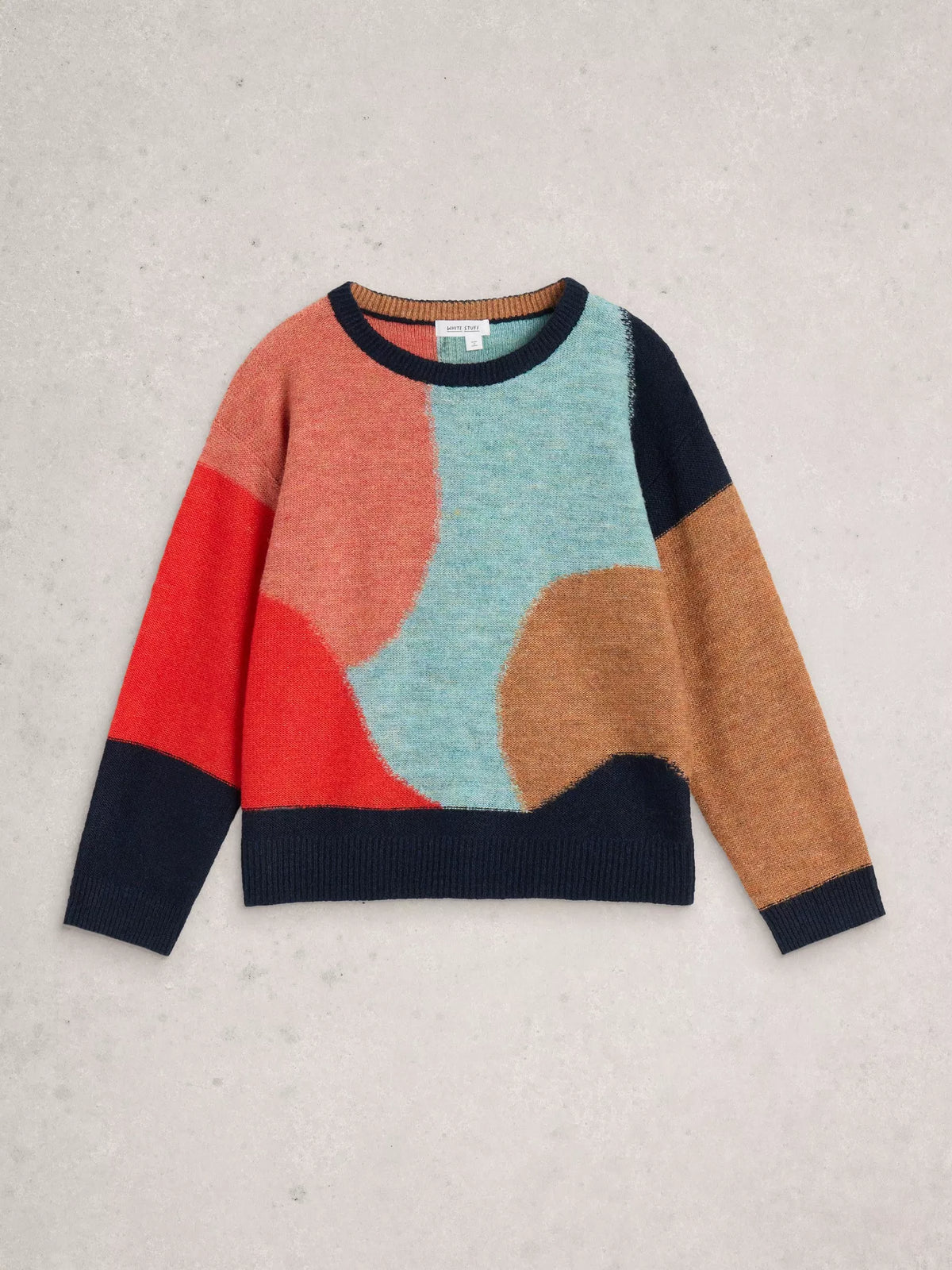 Colorful sweater with abstract design on a light gray background
