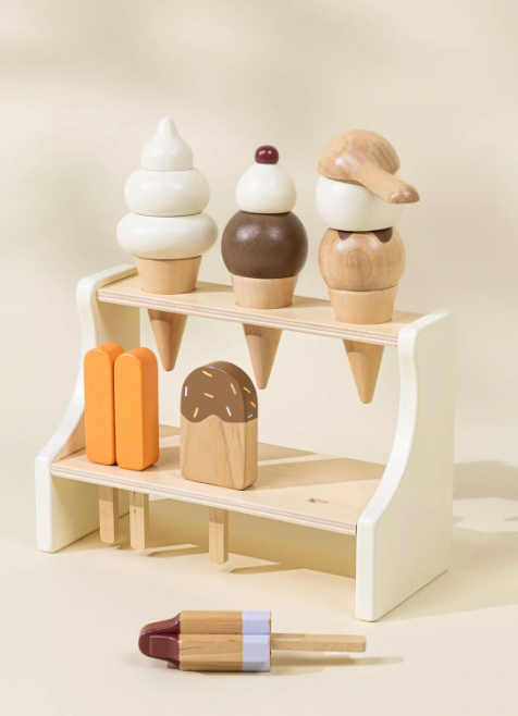 Wooden ice cream cones and a stand on a light background