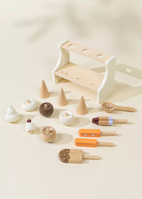 Set of wooden ice cream toys and cones on a light background