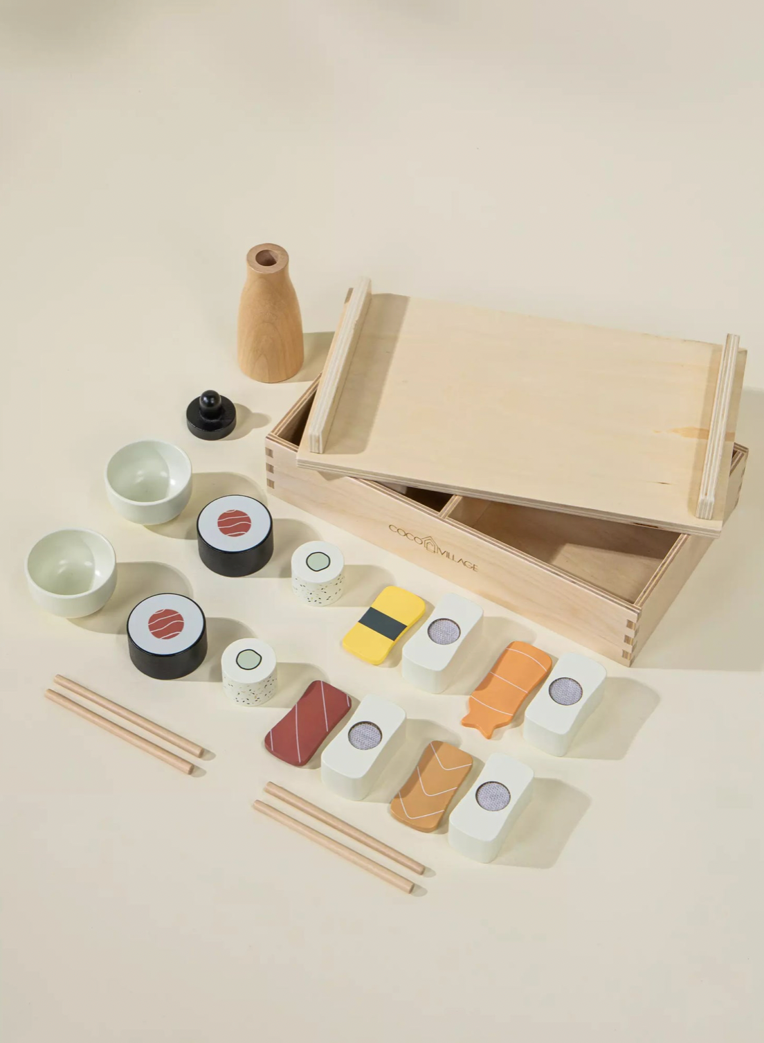 Wooden toy sushi set with a box on a light background