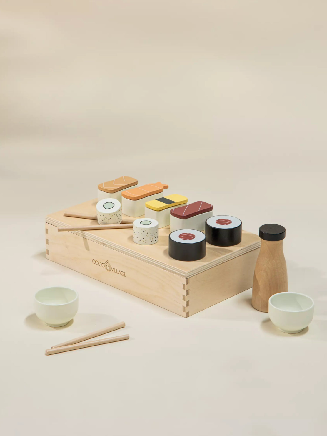 Wooden toy sushi set with accessories on a beige background