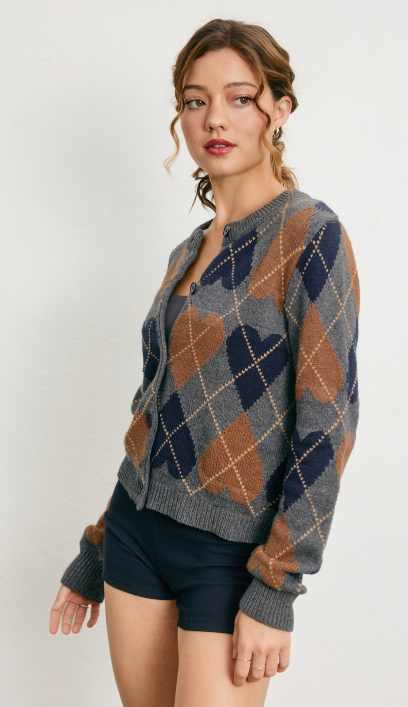 Woman wearing a patterned cardigan on a white background