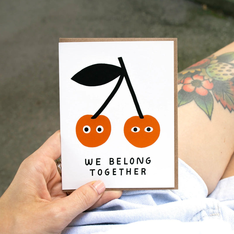 Card with cherries and 'We Belong Together' text 