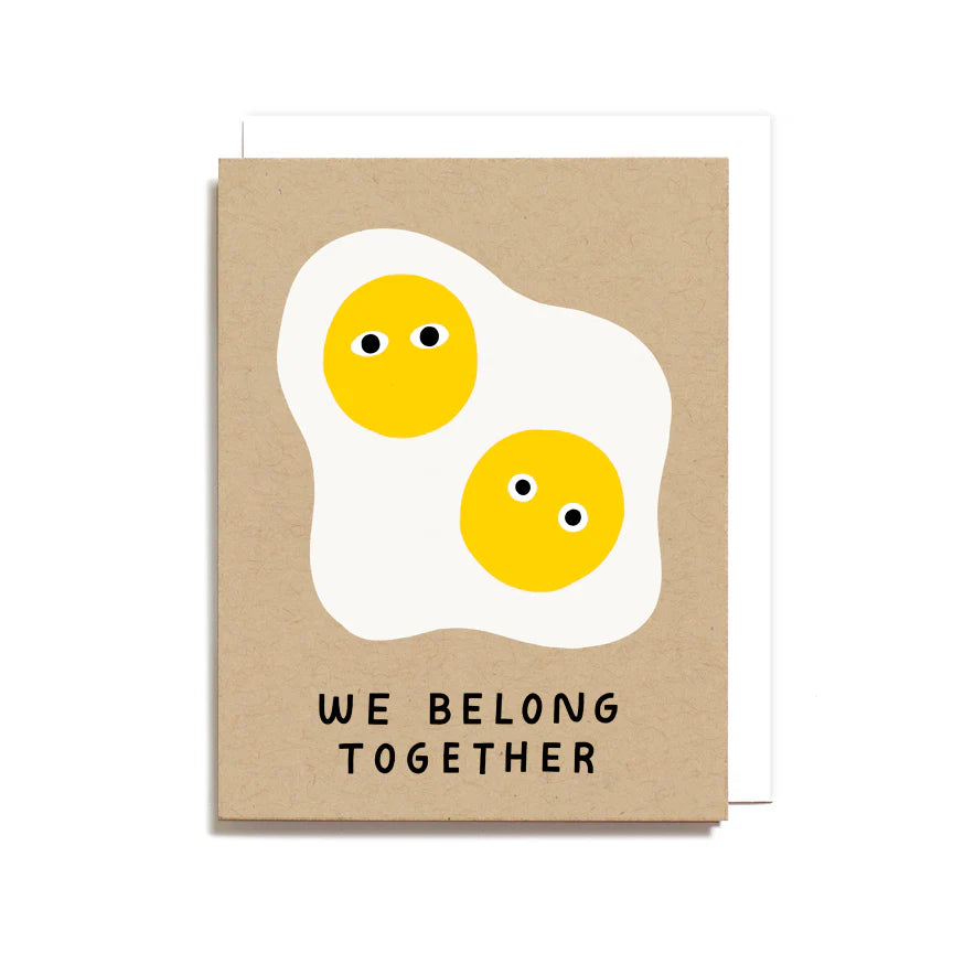 Card with cartoon eggs and 'We Belong Together' text on a brown background