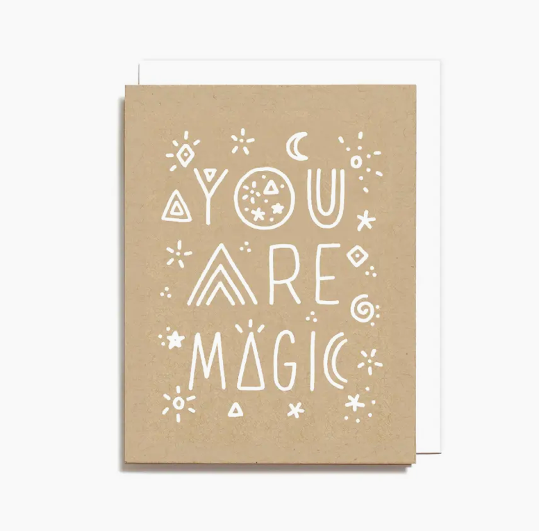 Kraft paper card with 'You are magic' text and geometric designs on a white background